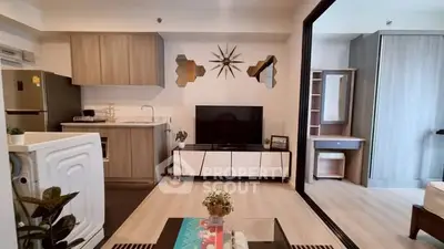 Modern living room with stylish decor and open kitchen layout in a contemporary apartment.