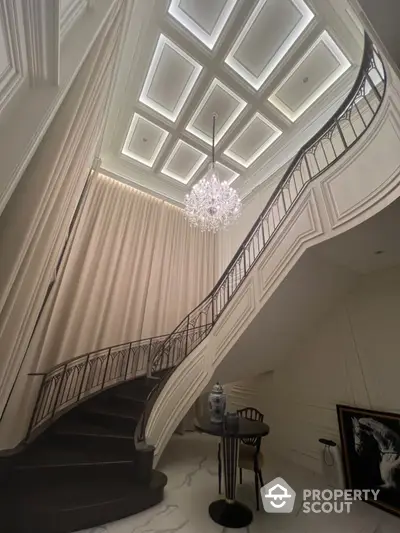 Luxurious staircase with elegant chandelier in upscale home interior