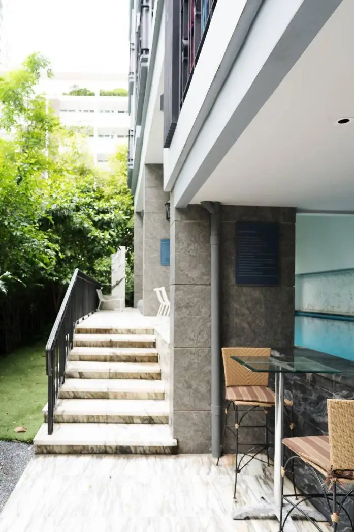 Chic outdoor area with poolside seating and lush greenery in modern building