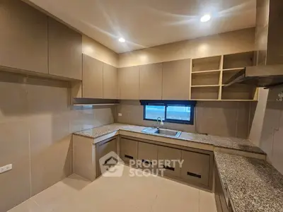 Spacious modern kitchen with sleek cabinetry and granite countertops