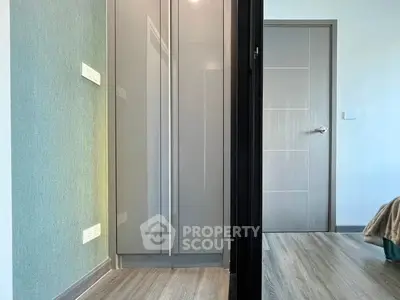 Modern apartment hallway with sleek wardrobe and bedroom entrance