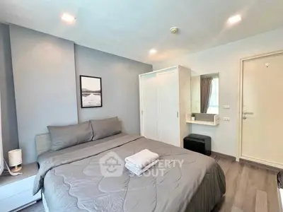Modern bedroom with stylish decor and ample storage in a cozy apartment.