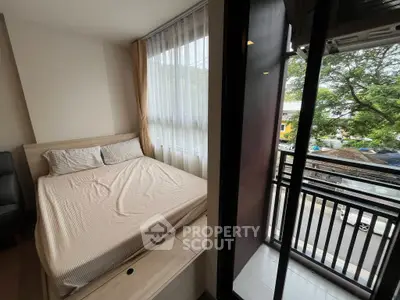 Cozy bedroom with balcony view in modern apartment