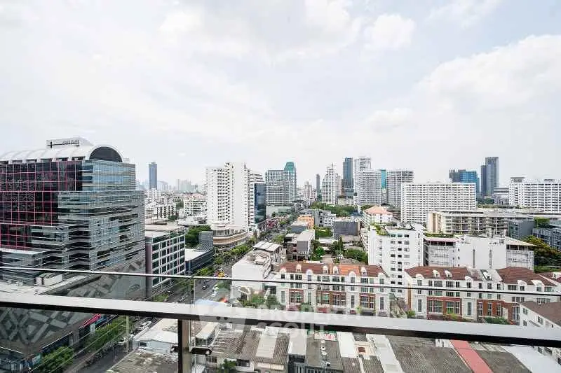 Stunning cityscape view from a high-rise balcony showcasing modern urban architecture and skyline.
