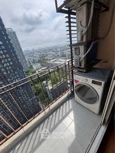 High-rise balcony with city view and laundry appliances