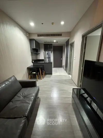 Modern apartment interior with sleek kitchen and cozy living area, perfect for urban living.