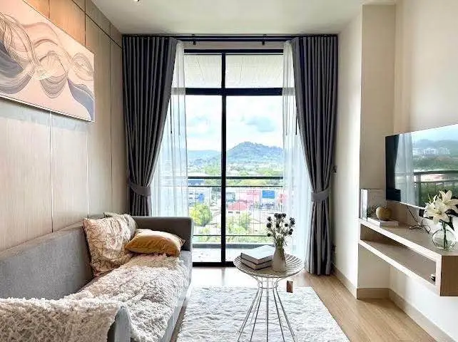 Stylish living room with cozy sofa and scenic view from large window.