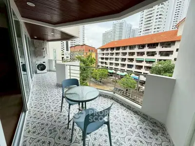 Spacious balcony with city view and stylish outdoor furniture