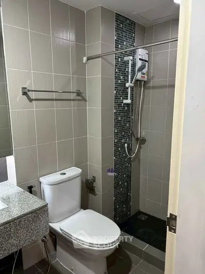 Modern bathroom with sleek shower and granite countertop