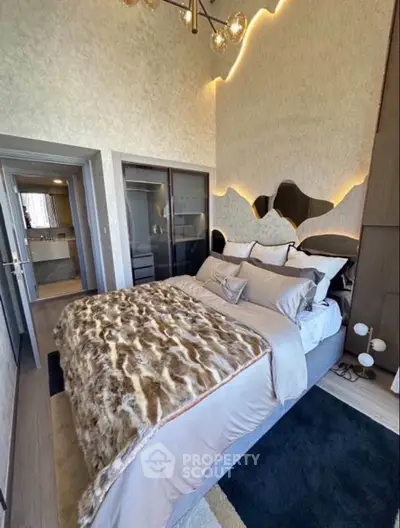 Luxurious bedroom with modern decor and unique wall design, featuring plush bedding and stylish lighting.