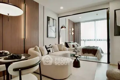 Modern open-plan living room with cozy seating and elegant bedroom view.
