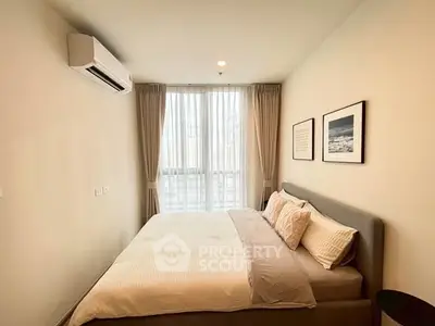 Modern bedroom with cozy bed and natural light from large window.