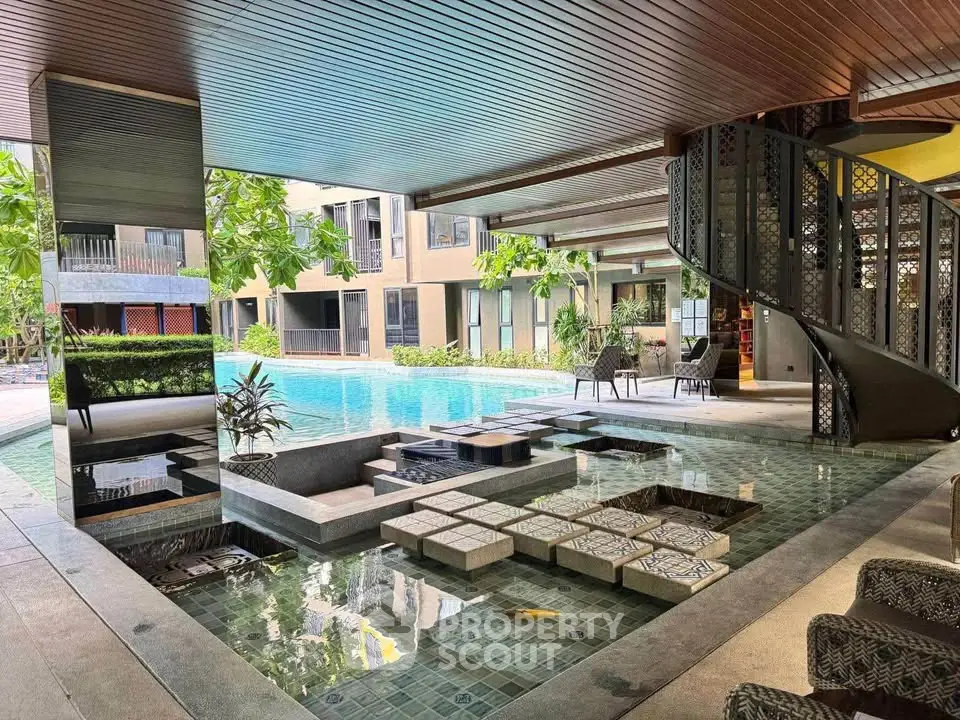 Luxurious apartment complex with stunning pool and modern spiral staircase