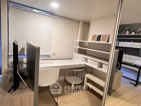 Modern study room with sleek desk, shelving, and contemporary decor in a stylish apartment.