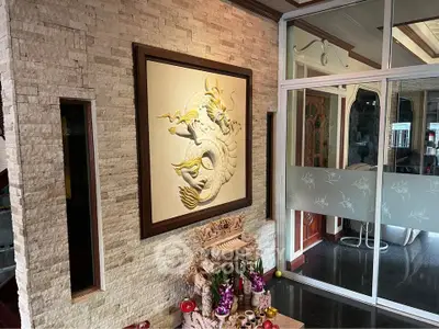 Elegant living room with unique wall art and traditional decor elements