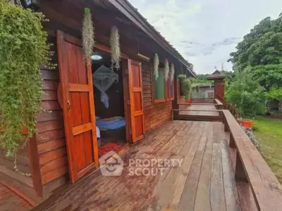 Charming wooden cabin with spacious balcony and lush greenery, perfect for nature lovers seeking tranquility.