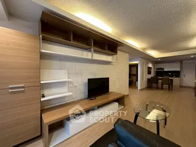 Modern living room with sleek wooden furniture and open layout, perfect for contemporary living.