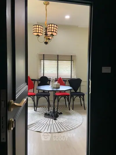 Charming dining area with unique chairs and elegant chandelier, perfect for cozy meals.