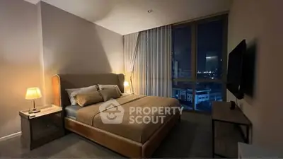 Luxurious bedroom with city view, modern furnishings, and ambient lighting for a cozy atmosphere.