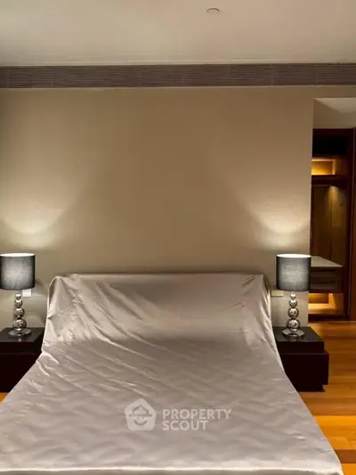 Luxurious bedroom with elegant lighting and sleek wooden flooring