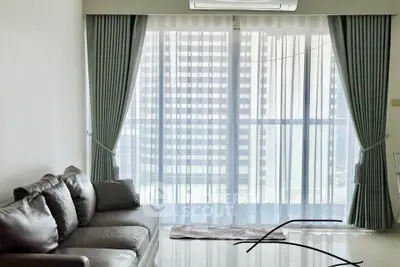 Spacious living room with elegant curtains and modern leather sofa