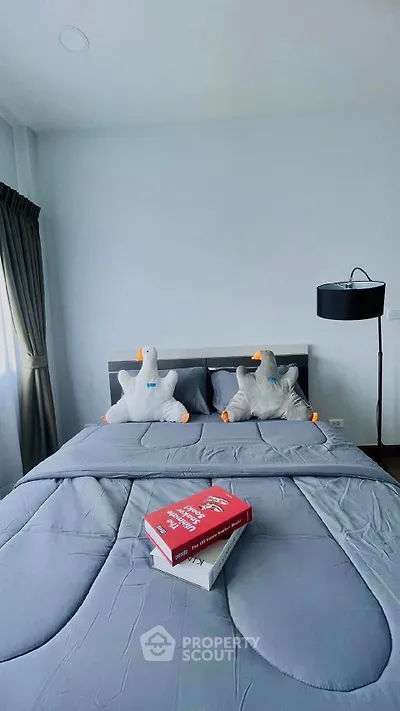 Cozy bedroom with plush bedding and unique duck pillows, perfect for relaxation.