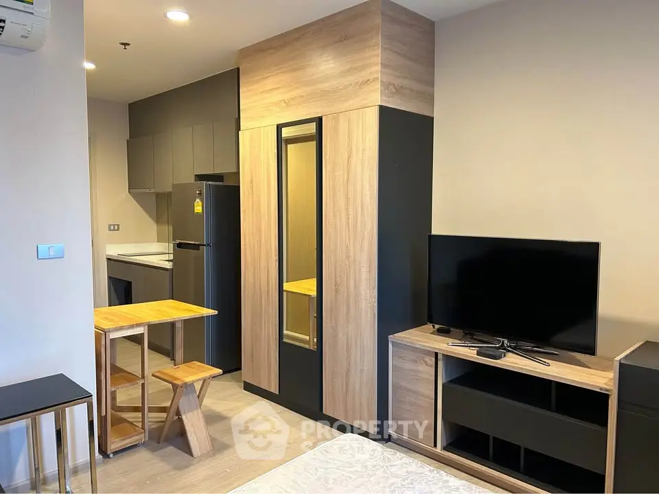 Modern studio apartment with sleek kitchen and cozy living area