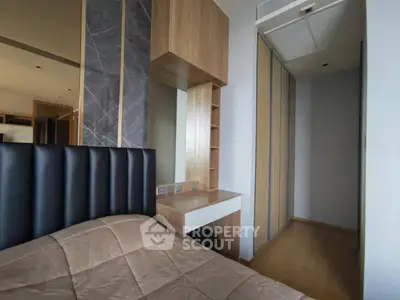 Modern bedroom with stylish headboard and built-in storage in a contemporary apartment.