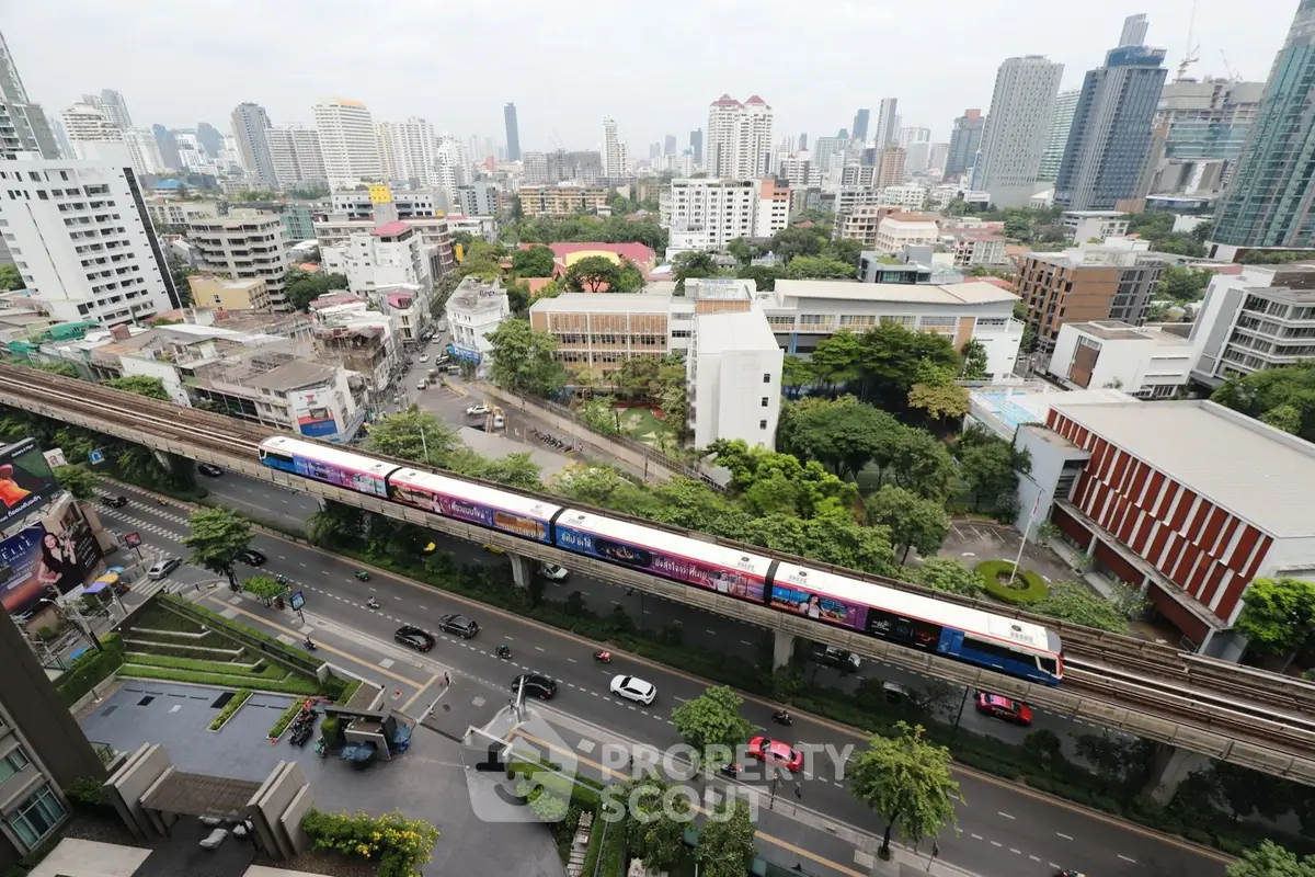 Stunning cityscape view with modern buildings and elevated train, showcasing urban living at its finest.
