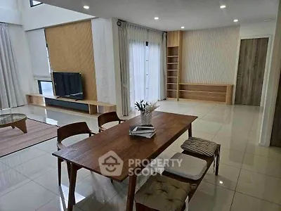Spacious modern living room with elegant dining area and natural light