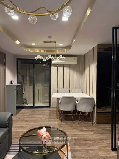 Modern living room with elegant dining area and stylish lighting fixtures.