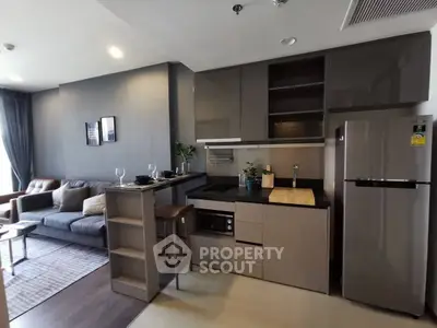 Modern open-layout kitchen and living room with sleek design and contemporary furniture.
