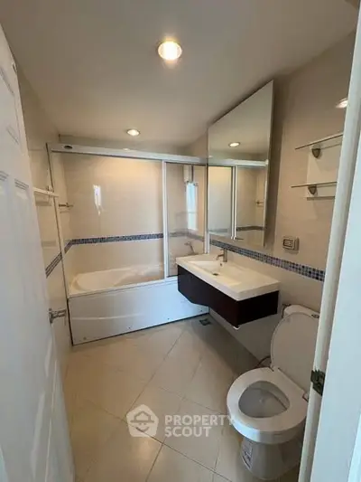 Modern bathroom with bathtub and sleek fixtures in a contemporary home.
