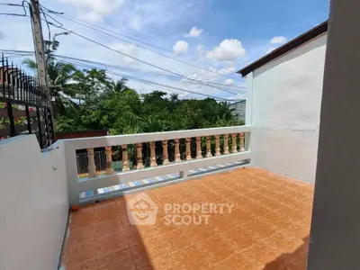 Spacious balcony with tiled flooring and scenic view of lush greenery, perfect for relaxation.