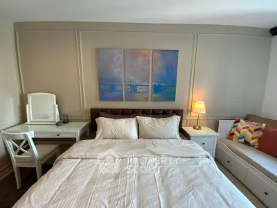 Cozy bedroom with elegant decor and comfortable bedding, featuring a stylish desk and ambient lighting.