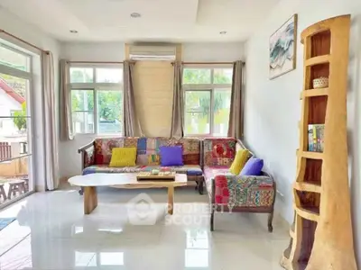 Bright and colorful living room with unique wooden furniture and large windows.
