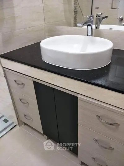 Modern bathroom with stylish sink and sleek cabinetry