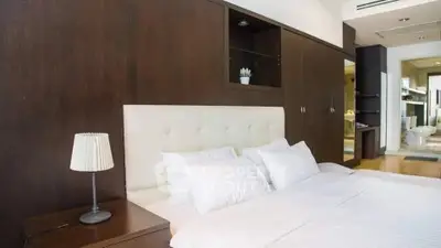 Luxurious bedroom with elegant wooden paneling and plush bedding