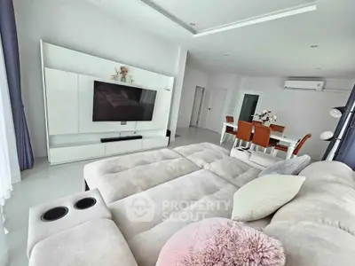 Spacious modern living room with plush seating and dining area, perfect for relaxation and entertainment.