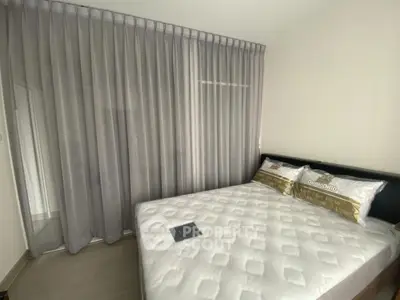 Cozy bedroom with elegant curtains and comfortable bedding