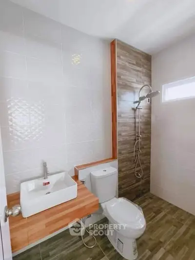 Modern bathroom with stylish shower and wooden countertop