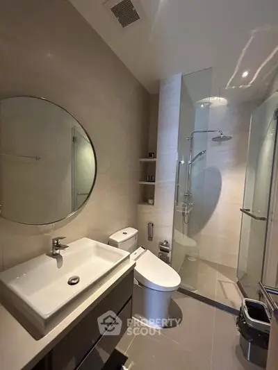 Modern bathroom with sleek fixtures and glass shower enclosure