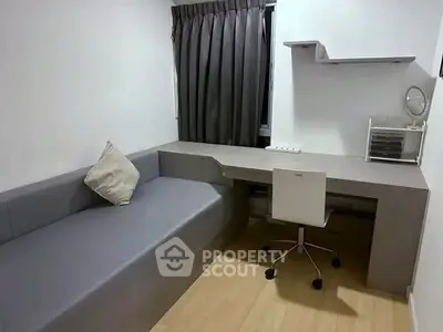 Modern study room with sleek desk and comfortable seating in minimalist design.