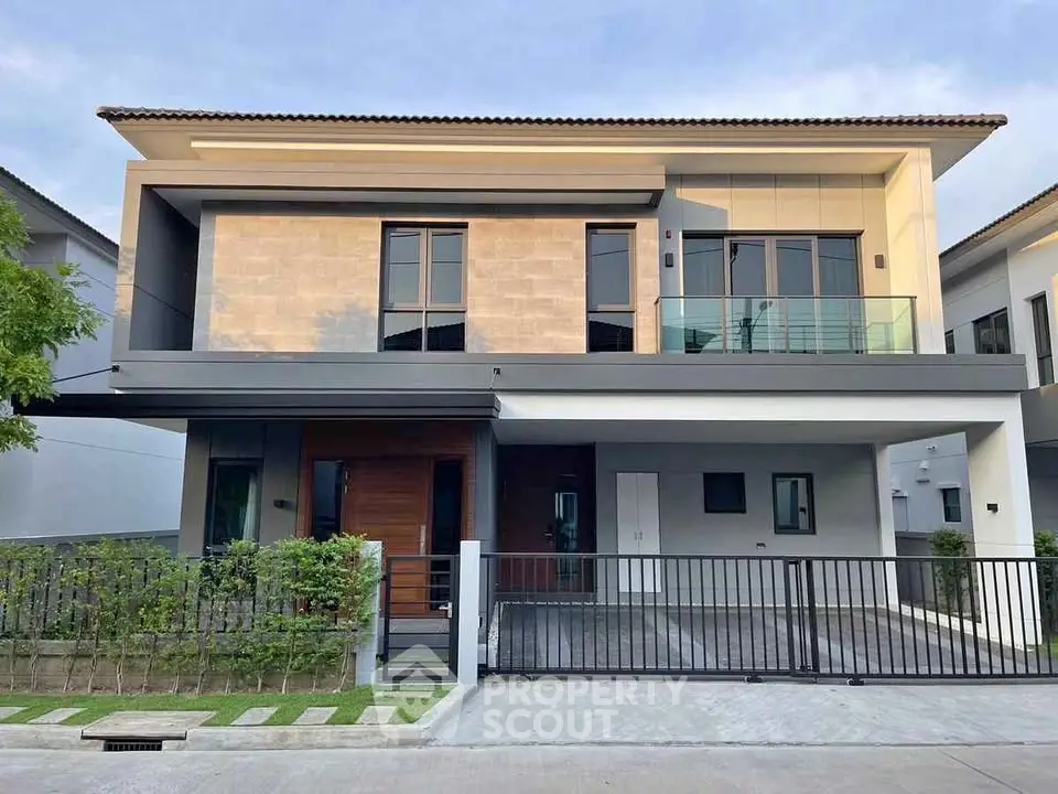 Modern two-story house with sleek design and spacious driveway in a serene neighborhood.