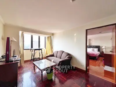 Spacious living room with cozy sofa and large windows for natural light