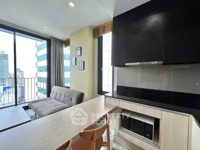 Modern living room with sleek kitchen and city view balcony in urban apartment