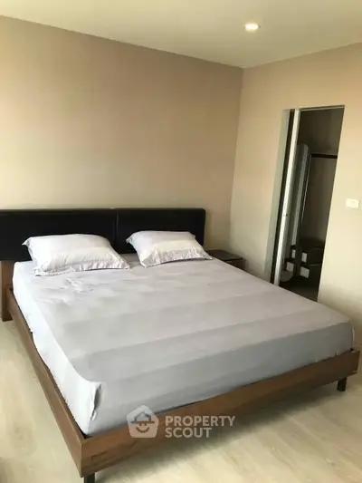 Spacious bedroom with modern decor and comfortable bed in a stylish apartment.