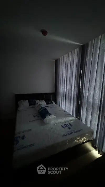 Cozy bedroom with large windows and modern furnishings, perfect for relaxation and comfort.