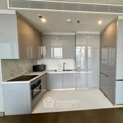 Modern kitchen with sleek cabinetry and built-in appliances in a luxury apartment.