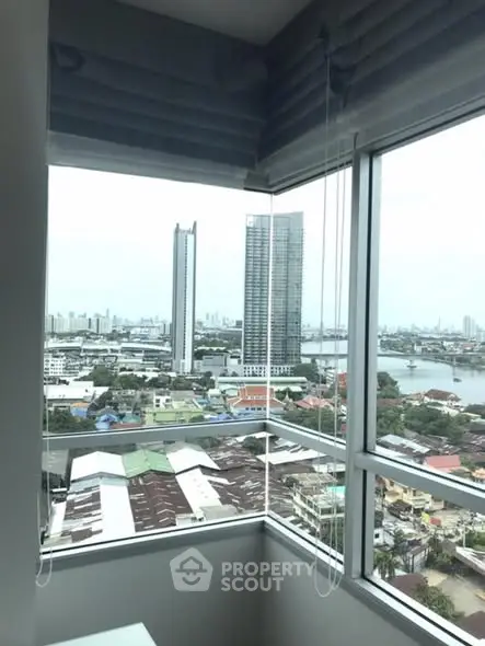 Stunning high-rise apartment view showcasing city skyline and river, perfect for urban living enthusiasts.